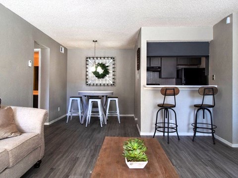 a living room with a couch and a table with bar stools