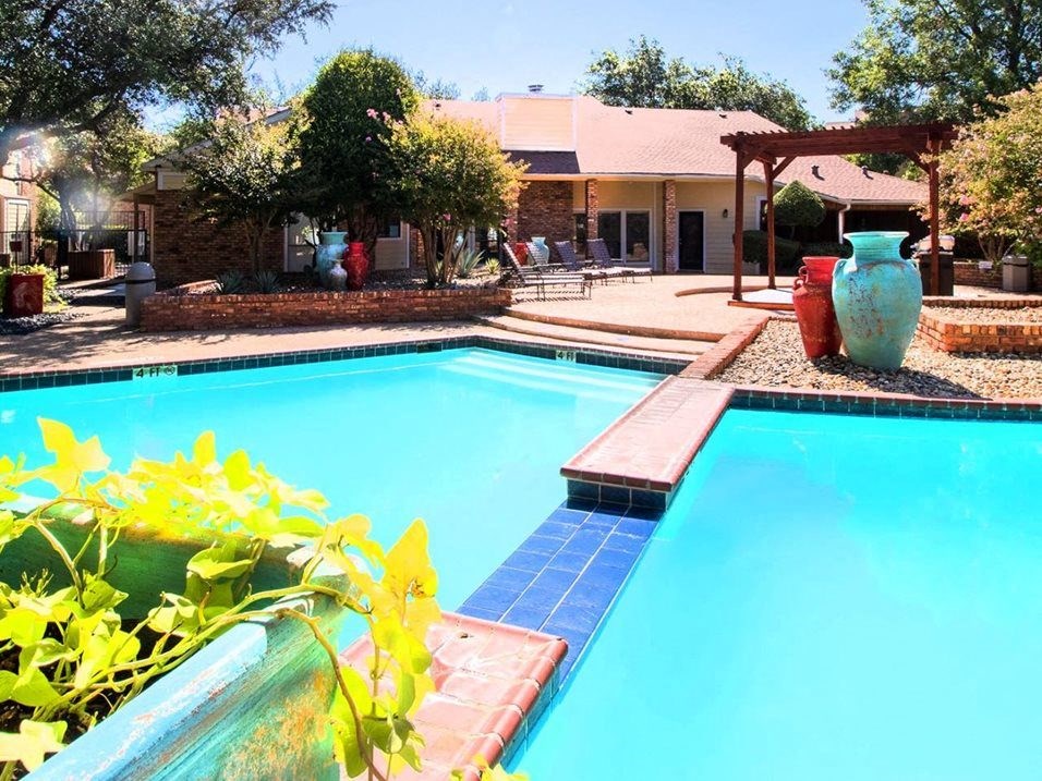 a swimming pool with a house in the background