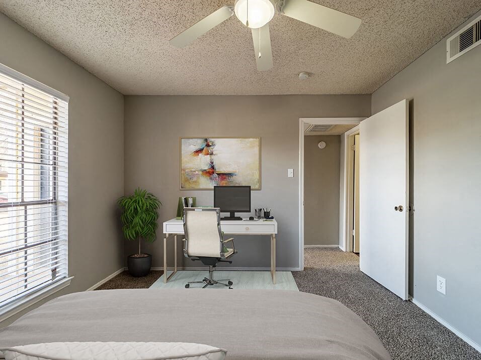 large bedroom with room for a desk and natural light