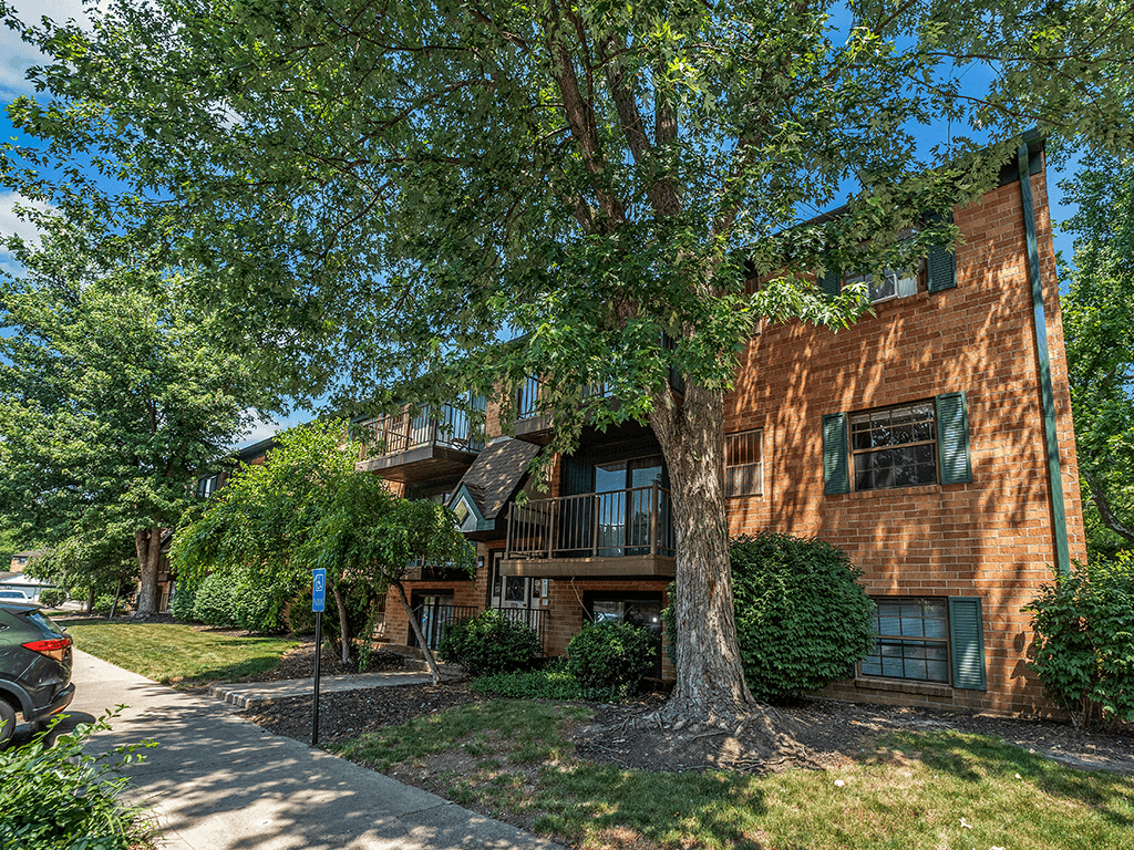 apartment building with mature shade trees