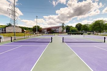 a tennis court with purple and green tennis courts
