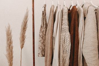a row of coats hanging on a rack