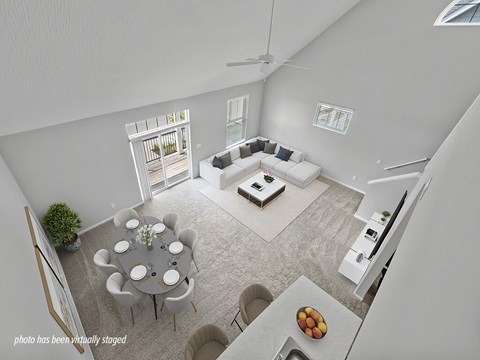 A modern living room with a dining table set for six.