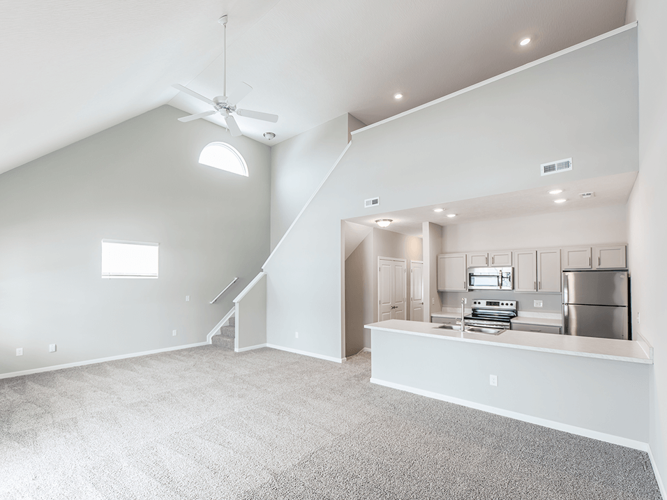 the living room and kitchen in The District at Ashland Apartments in Ohio