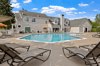 A large house with a pool in the backyard.