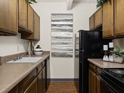 a kitchen with a sink and a refrigerator