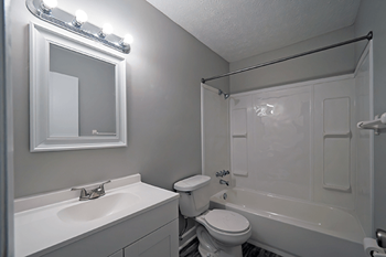 a bathroom with a sink toilet and a tub