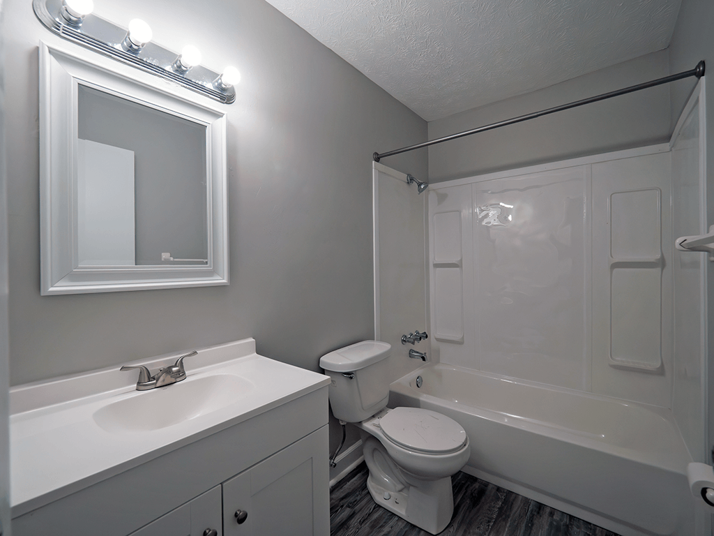 clean bathroom with a sink toilet and tub