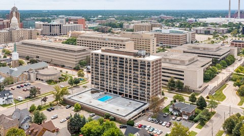 A large building with a pool in the middle of a parking lot.