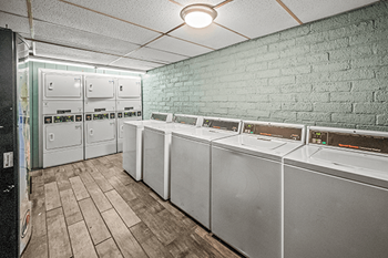 A row of washing machines in a laundromat.