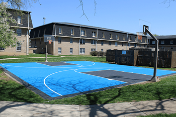 A basketball court with a blue surface and white lines.