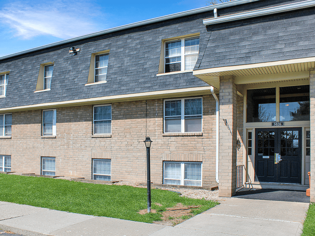 A brick building with a black door and windows.