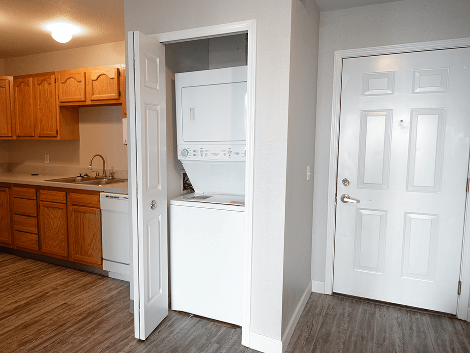 a kitchen with white appliances and wooden cabinets