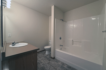 A bathroom with a toilet, sink, and bathtub.