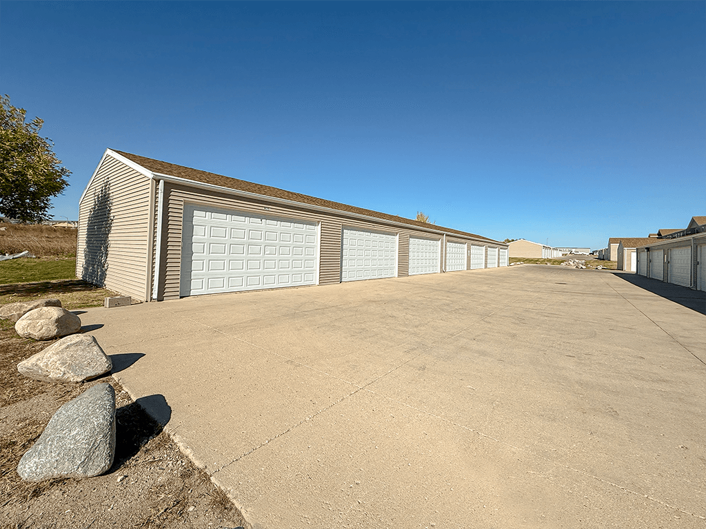 A long building with a garage door is in the foreground.