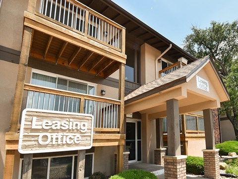 leasing office sign in front of an apartment building