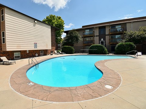 a swimming pool in front of an apartment building