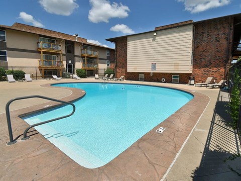 a swimming pool with a building in the background