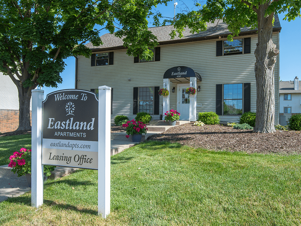 a leasing office sign in front of a house