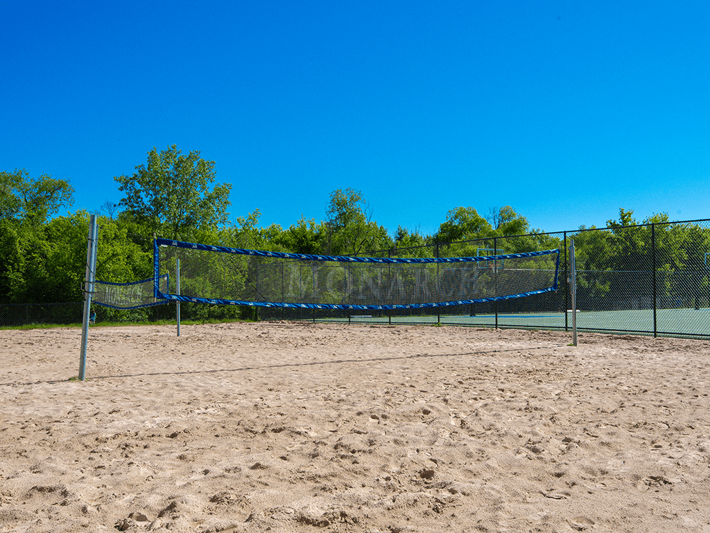 a tennis court with a net in the sand