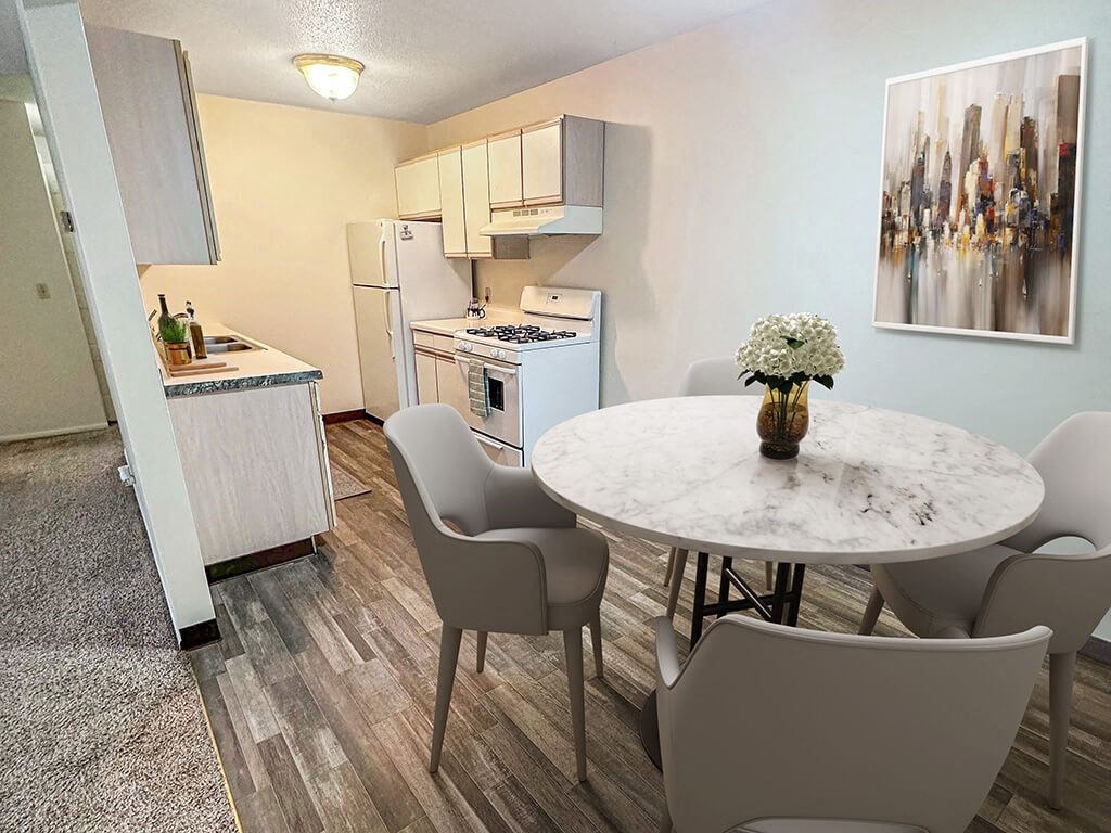 A kitchen with a table and chairs in front of it.