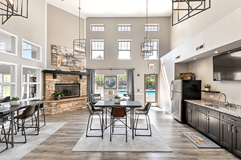 The Club house at reserve at eagle ridge apartments with a fireplace and vaulted ceilings.