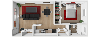 A living room with a black couch and a red accent wall.