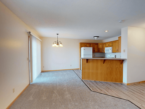 A kitchen area with a counter and cabinets.