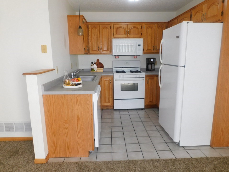 kitchen in apartment at french creek with dishwasher and microwave