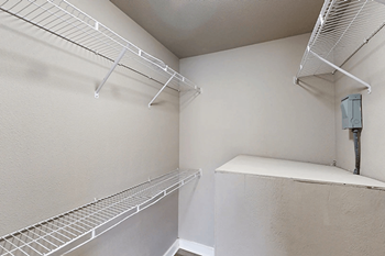 A white refrigerator with two shelves and a water dispenser on the right side.