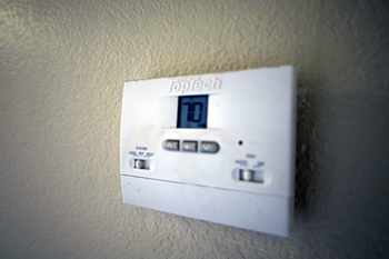 A white thermostat with the number 10 on it.