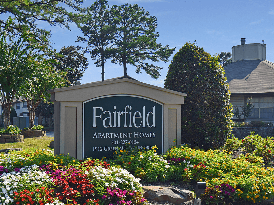 welcome sign for Fairfield Apartments Homes in front of flowers