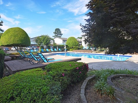 apartment with swimming pool and lounge chairs
