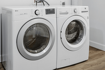 Two white LG front load washing machines.