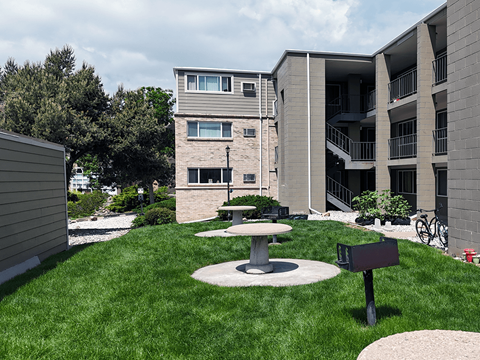 A modern building with a green lawn in front.
