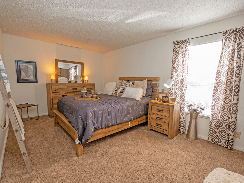 a bedroom with a bed and dresser