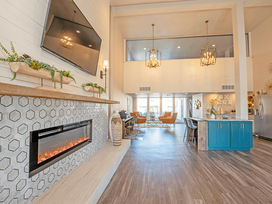 a living room with a fireplace and a television