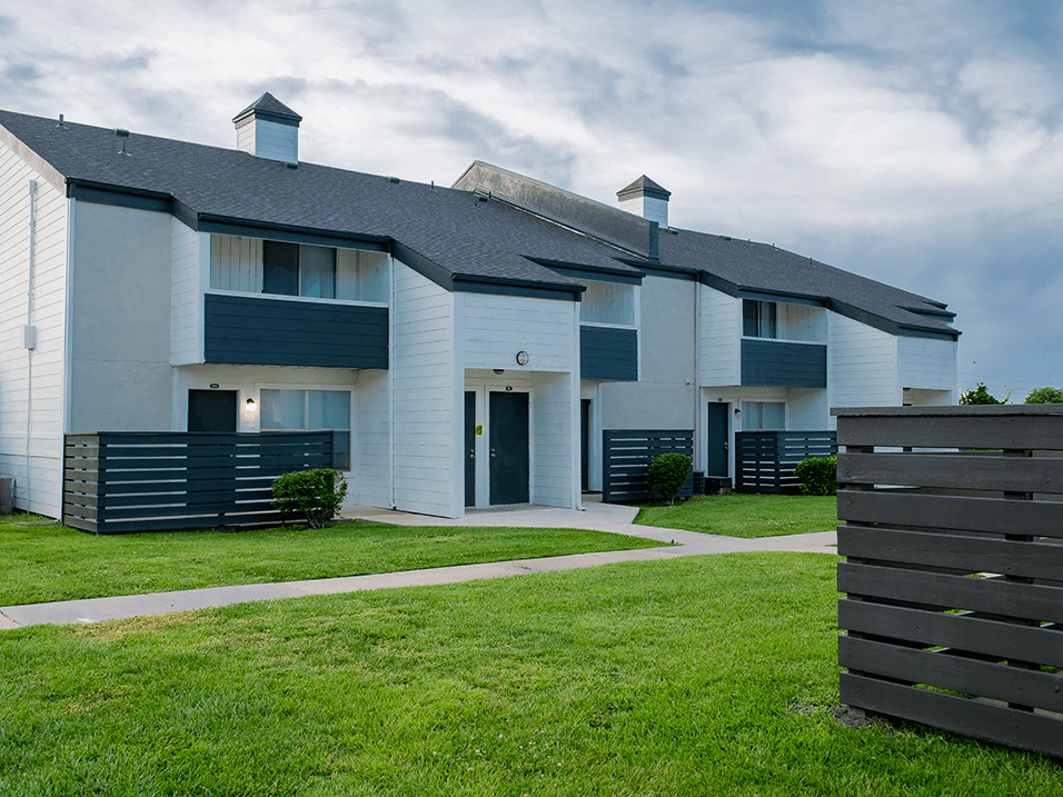 a picture of a white and blue apartment complex