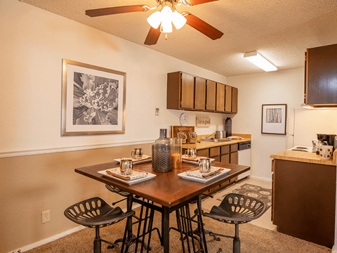 an open kitchen and dining room with a table and chairs