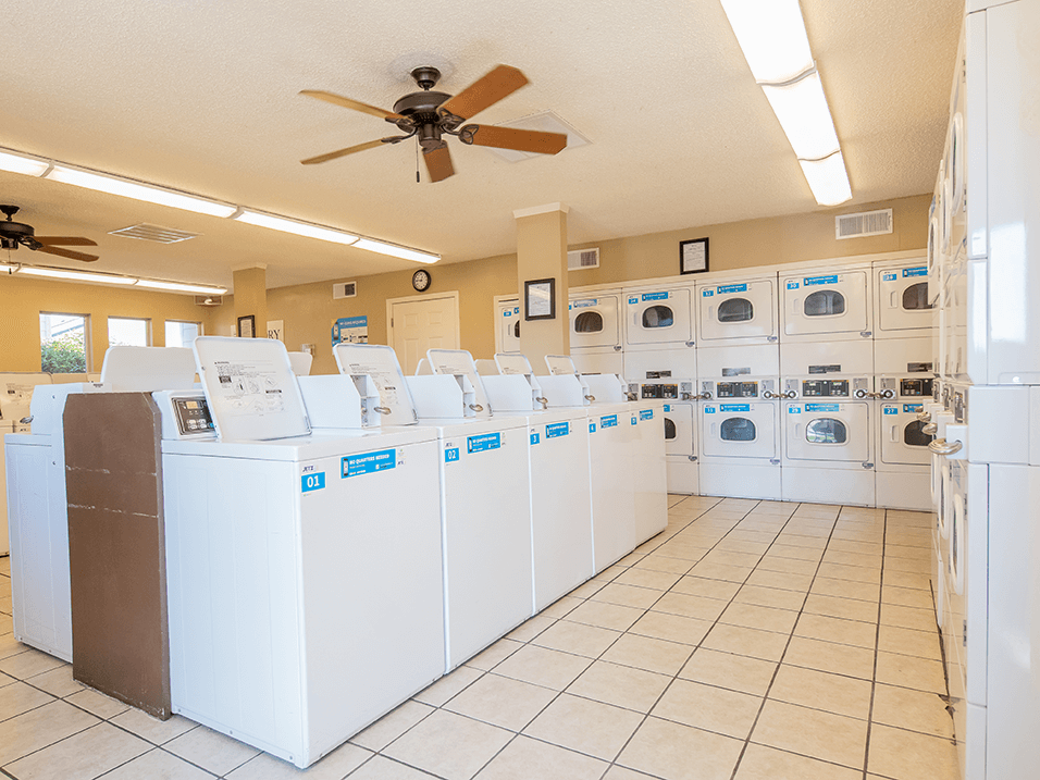 the laundry room at the enclave at woodbridge apartments in sugar land, tx