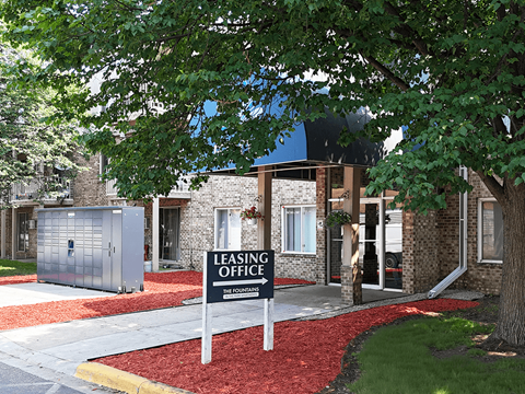 A leasing office is located in a building with a brick facade.