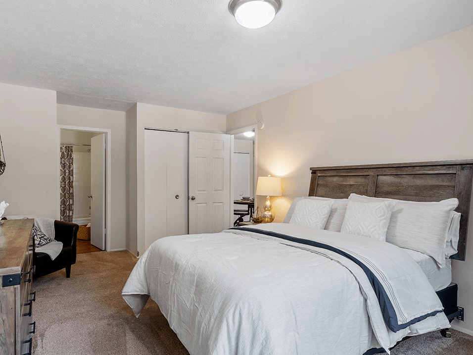 a bedroom with a bed and a desk