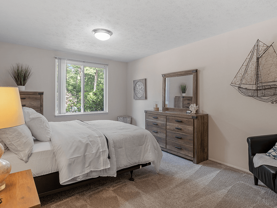 a bedroom with a bed and a dresser