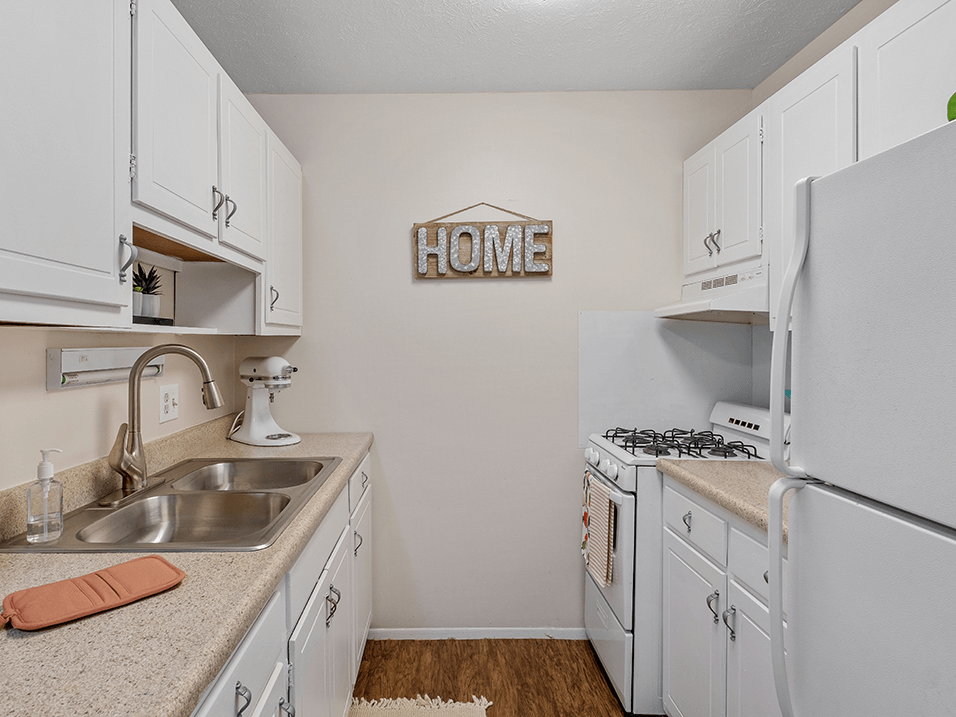 a kitchen with white cabinets and white appliances