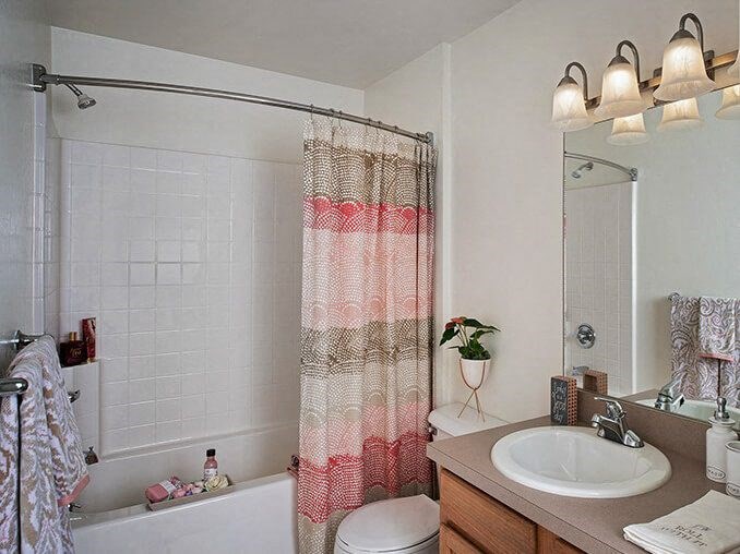 full bathroom with tup and storage area