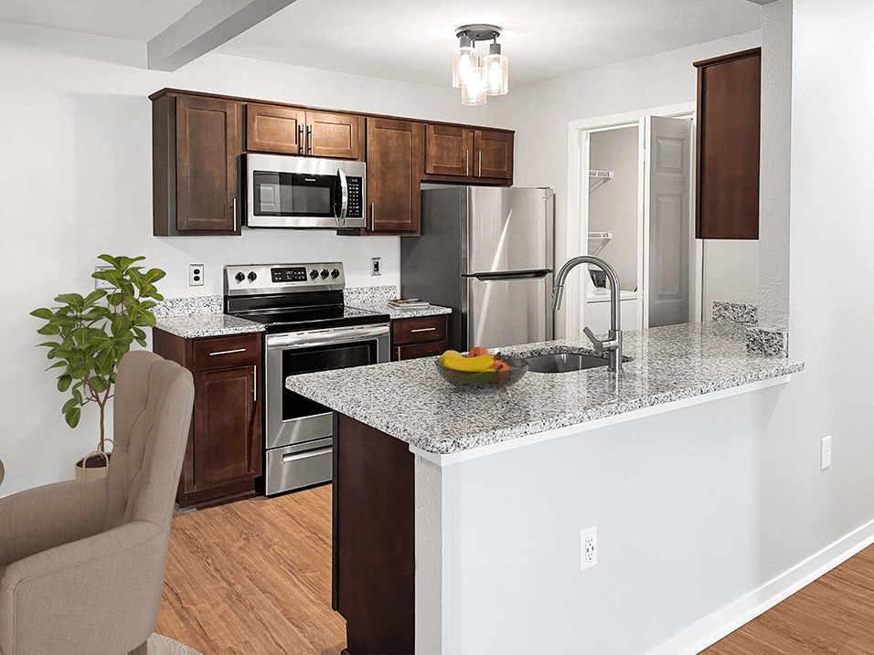 a kitchen with stainless steel appliances and a granite counter top