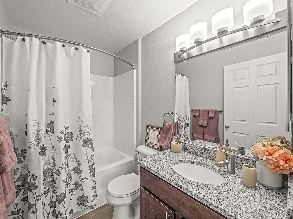 full bathroom that is attached to the primary bedroom