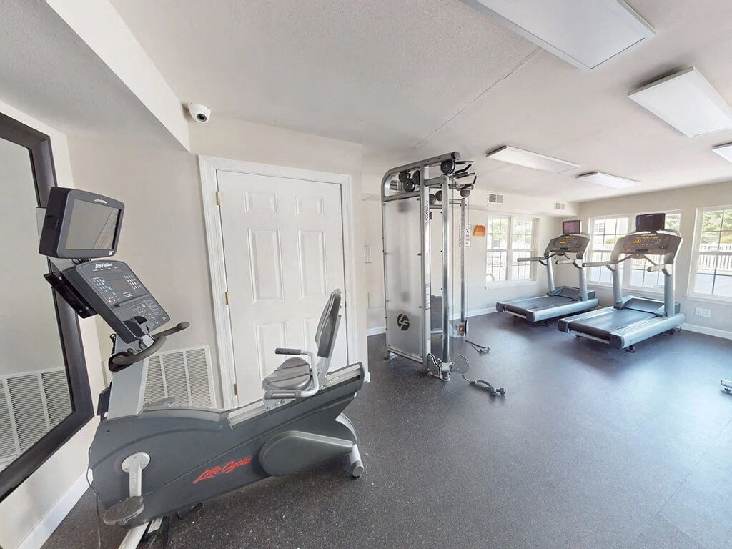 fitness center with a treadmill, elliptical machines, and other exercise equipment