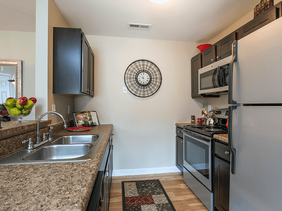 a kitchen with stainless steel appliances and granite counter tops