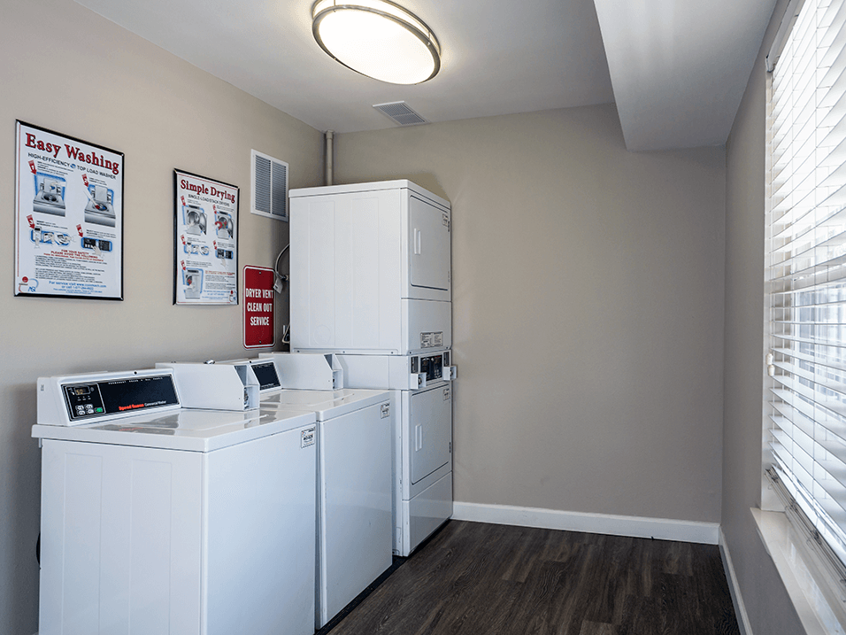 apartment complex laundry room with a washer and dryer